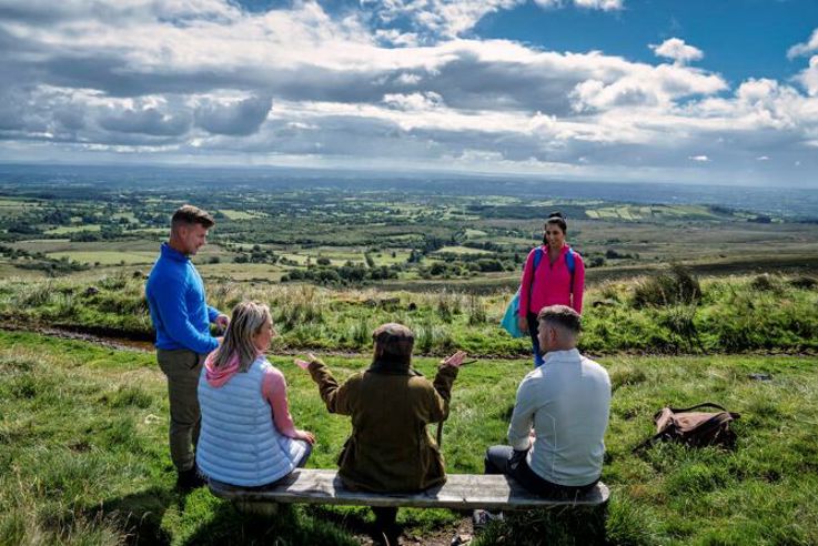 A tour guide takes a group on The Emigrants Walk 